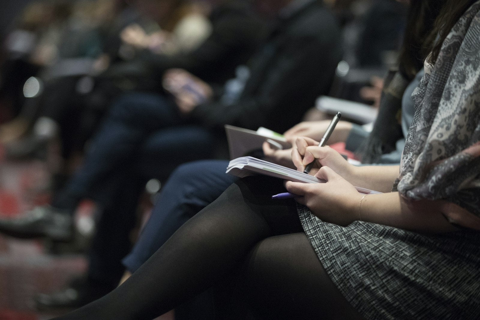 Delegates taking notes in an executive seminar
